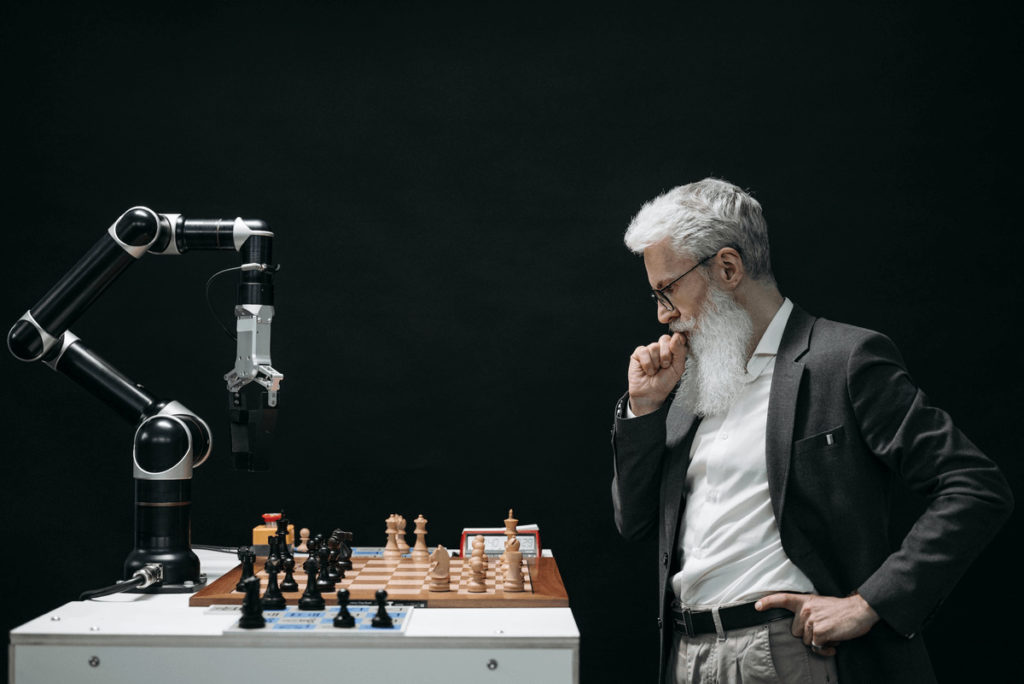 man playing chess against a computer